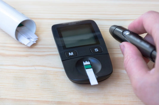 woman holds a glucometer and do a blood test